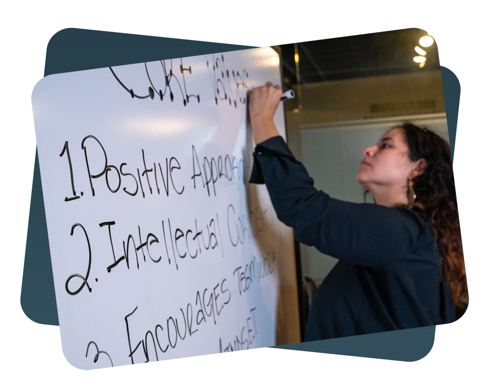 woman writing on a whiteboard