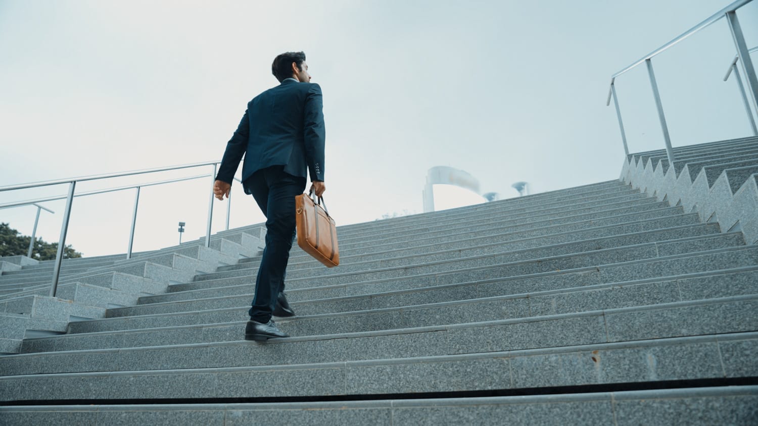 closeup image of business man walking up stairs in low angle camera. exultant.