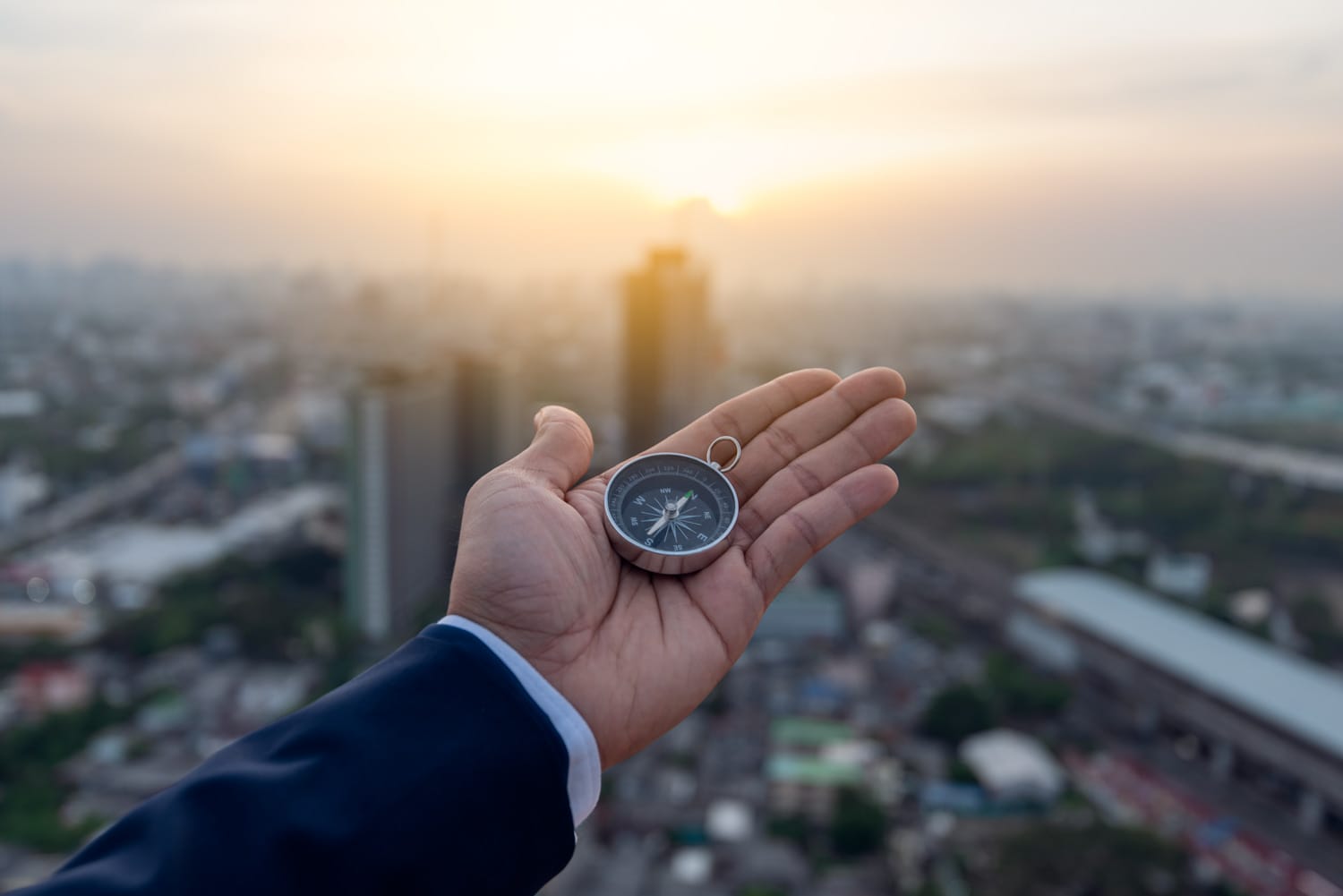Businessman holding a navigation compass in hand and define mark businessman holding a navigation compass in hand and define mark